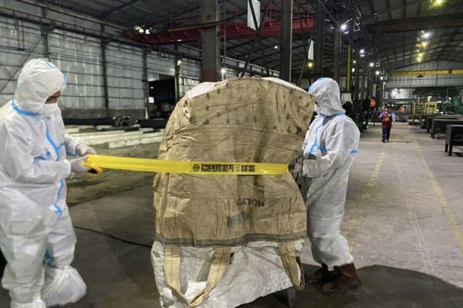 Karyawan industri kayu memeriksa bahan dengan alat ukur di pabrik kayu besar Indonesia.