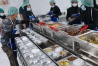 Petugas Satuan Pelayanan Pemenuhan Gizi (SPPG) menyiapkan paket makanan dalam Program Makan Bergizi (MBG) di dapur pelayanan. (Istimewa/Wawasannews)