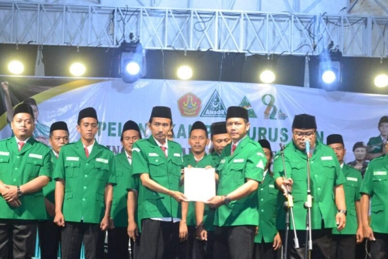 Perwakilan Pengurus Wilayah GP Ansor Jawa Tengah menyerahkan dokumen kepengurusan secara simbolis kepada jajaran PAC GP Ansor Brangsong saat prosesi pelantikan pengurus di halaman Gedung MWC NU Brangsong, Desa Sidorejo, Kendal, Sabtu (9/5/2026). (Istimewa/Wawasannews)